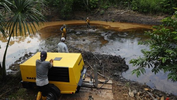 Employees of state-owned Petroecuador work on environmental cleansing operations of a 30-year old oil spillage in 2011.