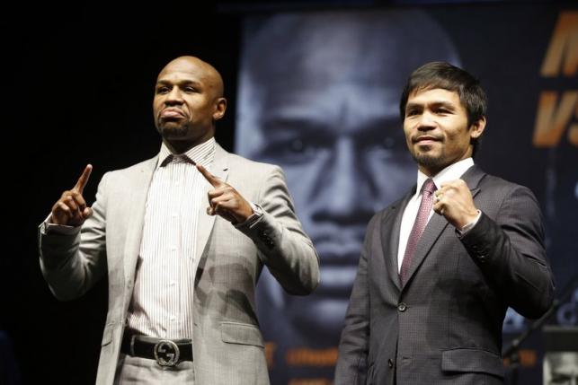 Eleven-time, five-division world boxing champion Floyd 'Money' Mayweather (L) and eight-division world champion Manny 'Pac-Man' Pacquiao pose at a news conference ahead of their upcoming bout, in Los Angeles, California March 11, 2015.
