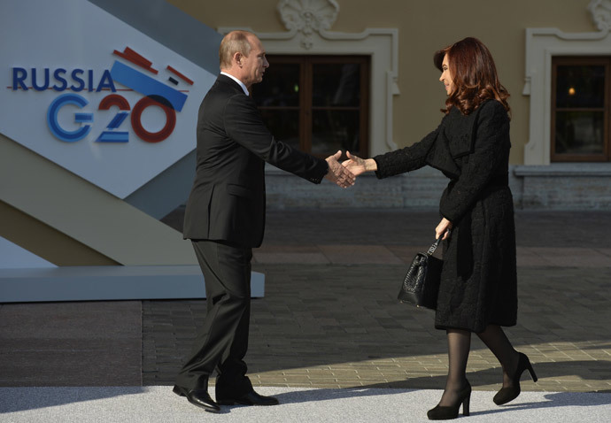 Russian President Vladimir Putin (L) welcomes Argentina’s President Cristina Fernandez de Kirchner at the start of the G-20 summit on September 5, 2013 in Saint Petersburg.