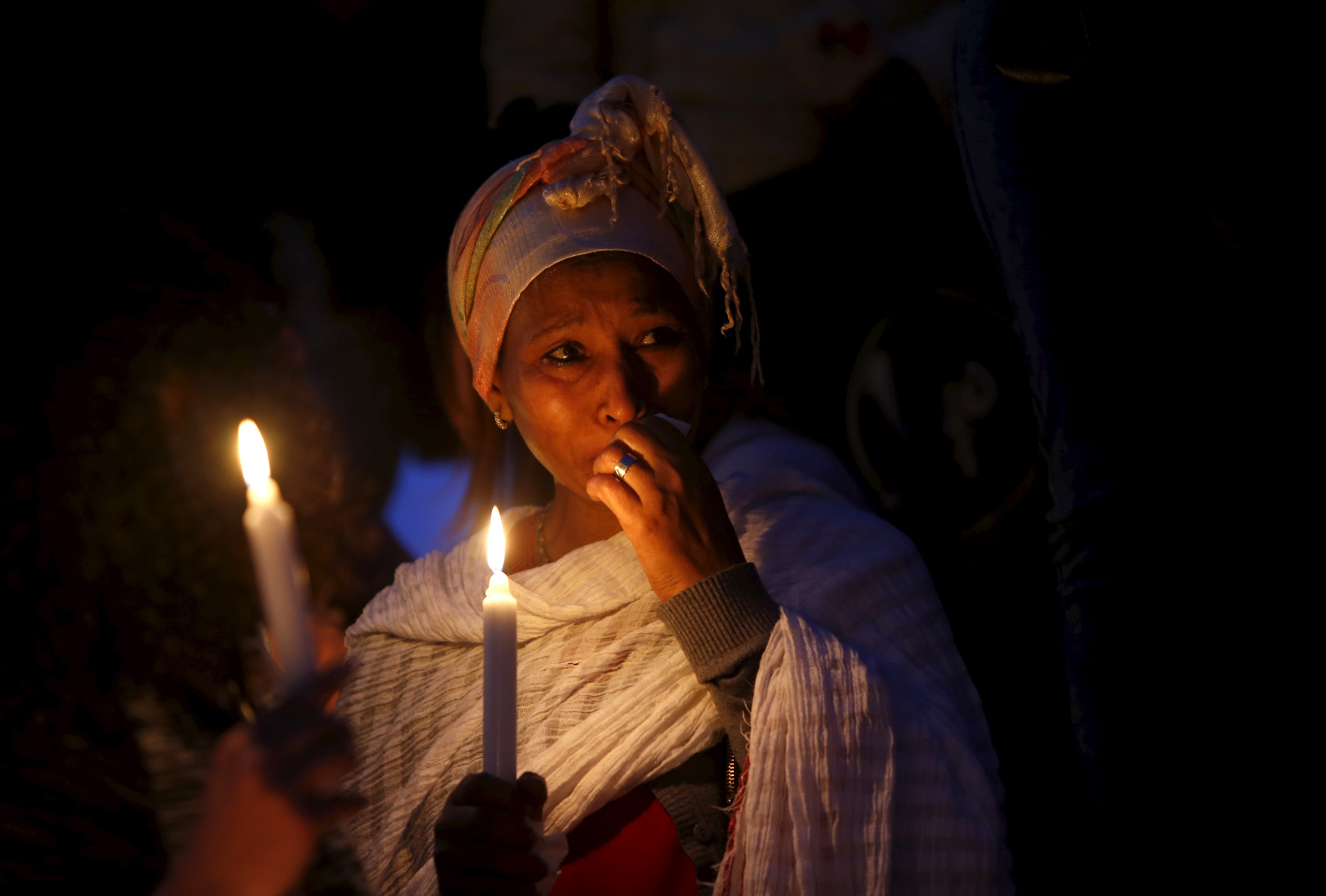 A migrant cries during a candlelight vigil to commemorate migrants who died at sea in Sliema, outside Valletta, April 22, 2015.