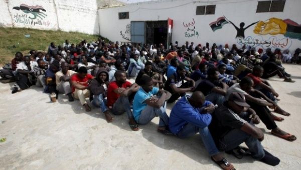 Migrants sit in Abu Saleem detention centre in Tripoli, Libya. The E.U. is considering increasing attacks against smuggling groups in Libya, but groups in Tripoli said they will 