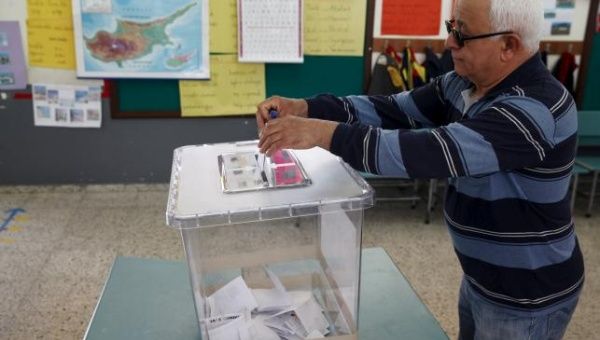 A Turkish Cypriot man casts his vote at a polling station in Famagusta, nothern Cyprus, April 19, 2015.