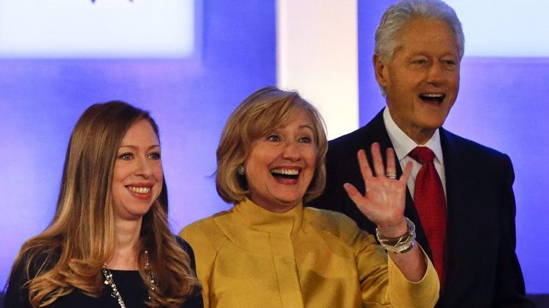 Chelsea (L) stands next to her parents Hillary Rodham Clinton and Bill Clinton at a Clinton Foundation event, Sept. 24, 2014.