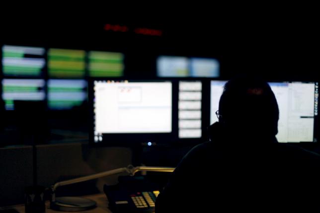 A cybersecurity expert monitors telecommunications traffic at a network operations center in Verizon
