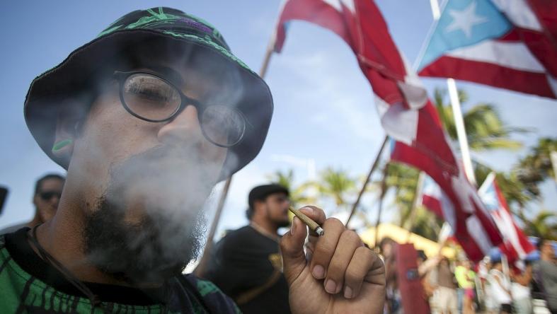 A demonstrator smokes marijuana during a protest outside Puerto Rico's Capitol building in San Juan April 20, 2015.