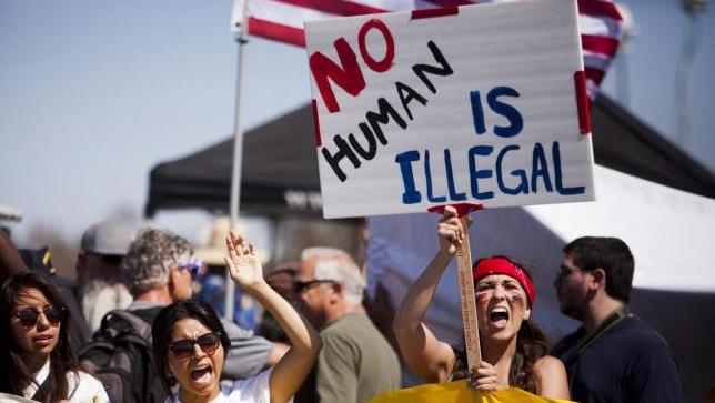 Demonstrators picket before the possible arrival of undocumented migrants on their way to be processed at the Murrieta Border Patrol Station in Murrieta, California, July 4, 2014.