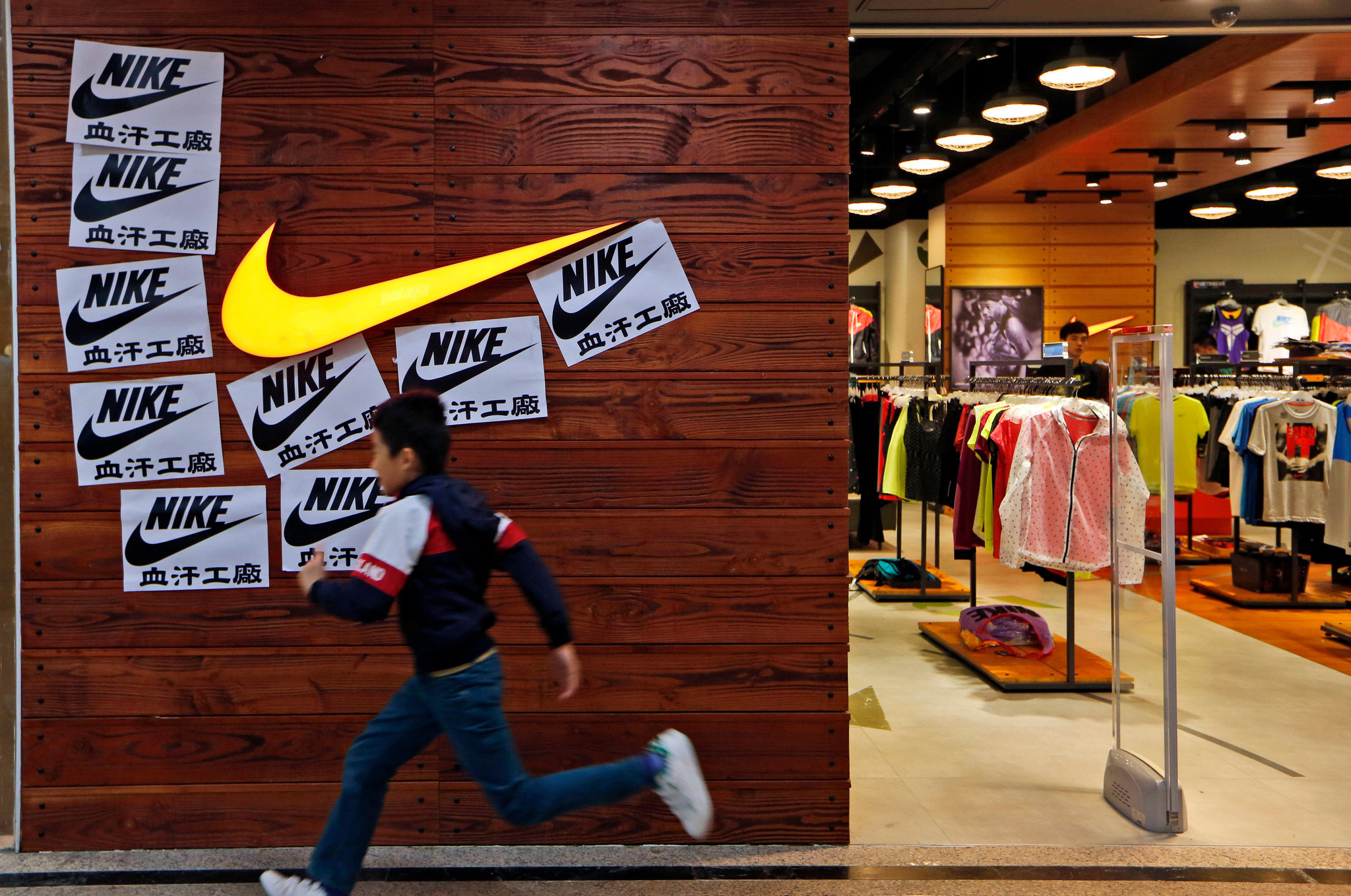 Chinese anti-sweatshop activists plaster a Nike store with 