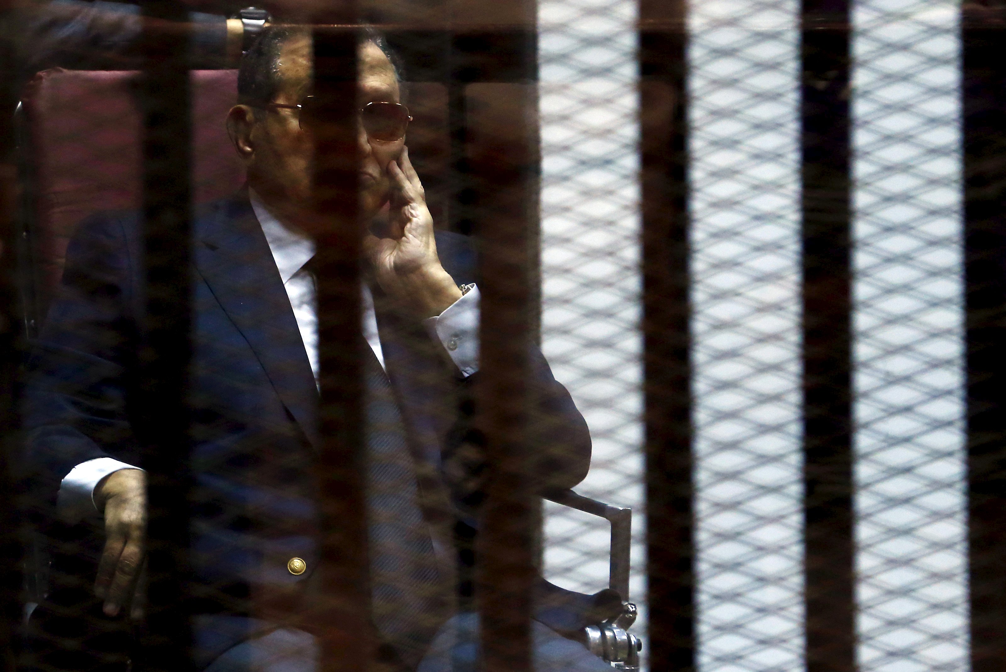 Egypt's former president Hosni Mubarak reacts inside a dock during his trial at the police academy, on the outskirts of Cairo.