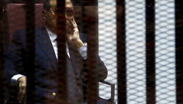 Egypt's former president Hosni Mubarak reacts inside a dock during his trial at the police academy, on the outskirts of Cairo.
