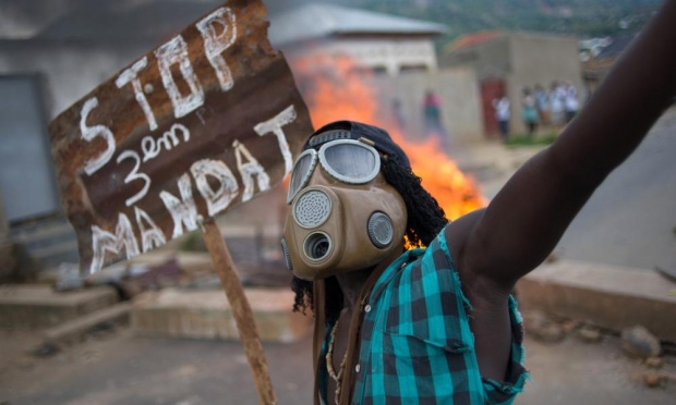 A protester in the Burundian capital of Bujumbura on Wednesday holds a sign that reads ‘Stop the third mandate’ of president Pierre Nkurunziza.