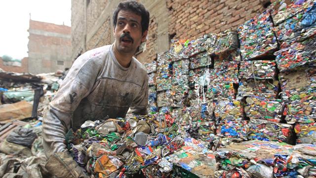 An Egyptian garbage collector works in the impoverished Al-Zabbalin area in Al-Mukatam neighbourhood in the Egyptian capital Cairo.