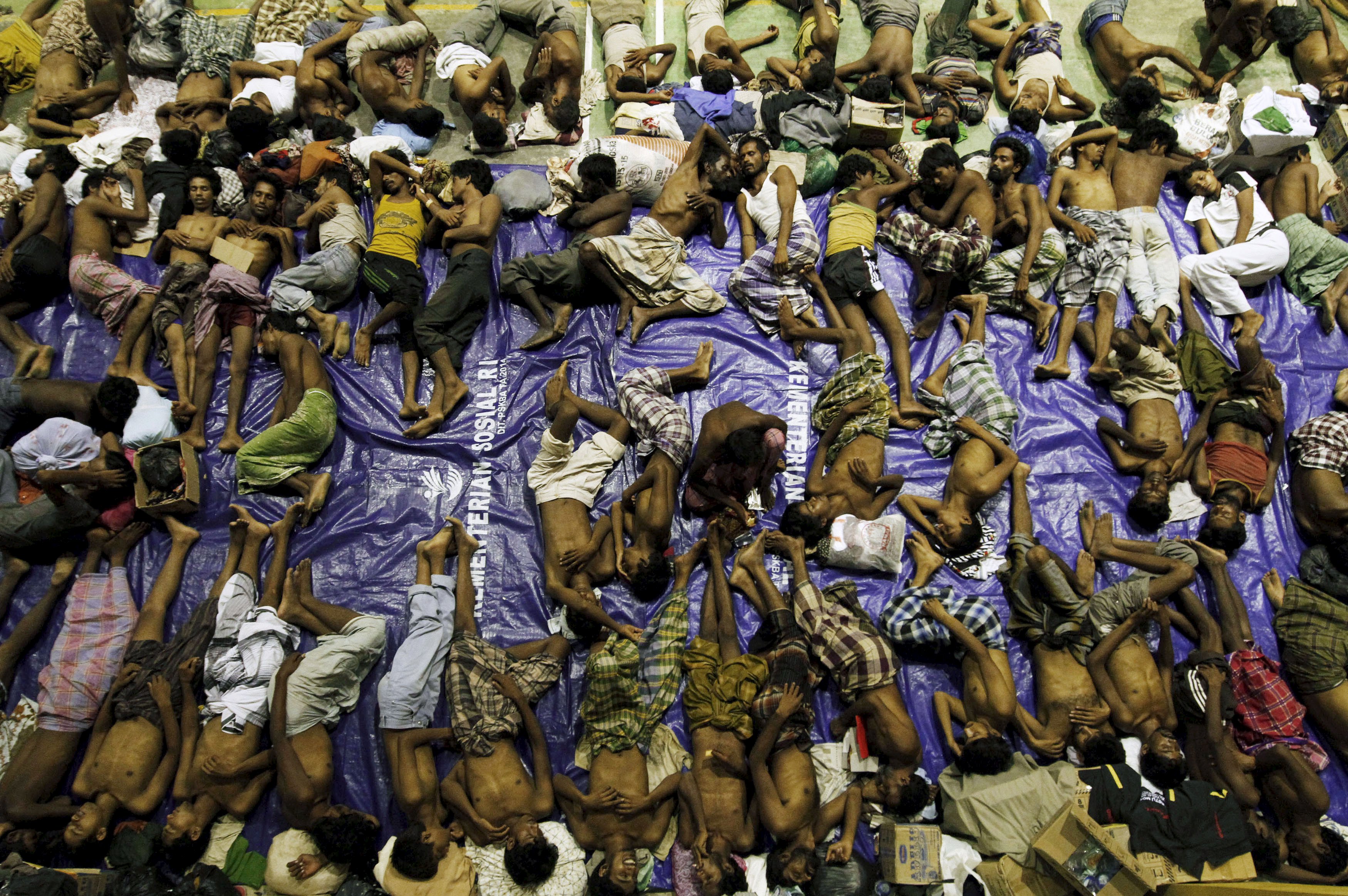 Migrants believed to be Rohingya rest inside a shelter after being rescued from boats at Lhoksukon in Indonesia's Aceh Province. Tens of thousands of Rohingya have fled Myanmar in the face of state-sanctioned discrimination.