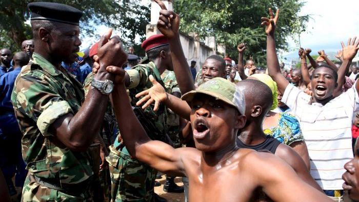 People celebrate with soldiers in Bujumbura, Burundi after the coup was announced.