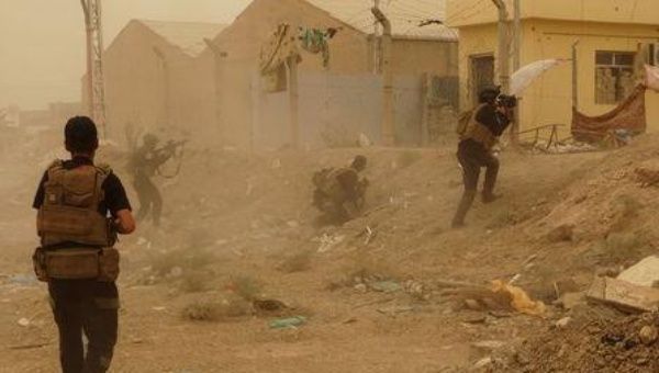 Iraqi security forces defend their headquarters against attacks by Islamic State group extremists in the eastern part of Ramadi in Anbar province, May 14, 2015.