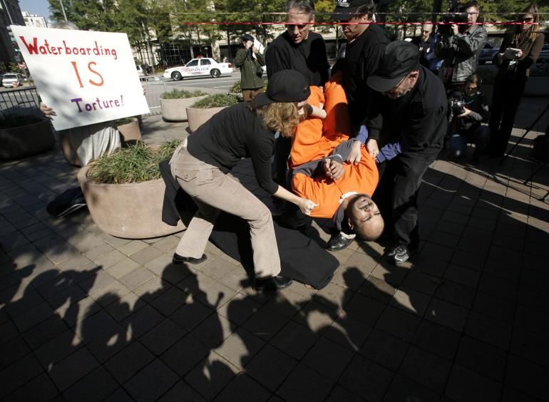 Demonstrators reenact 'waterboarding', a torture technique used by the CIA.