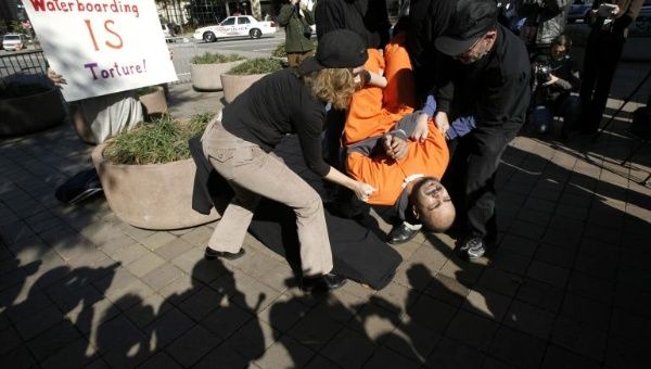 Demonstrators reenact 'waterboarding', a torture technique used by the CIA.