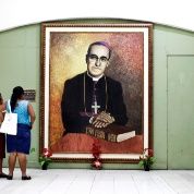 Women look at a painting of Archbishop Romero, Tuesday February 3, 2015, at the Metropolitan Cathedral in San Salvador.
