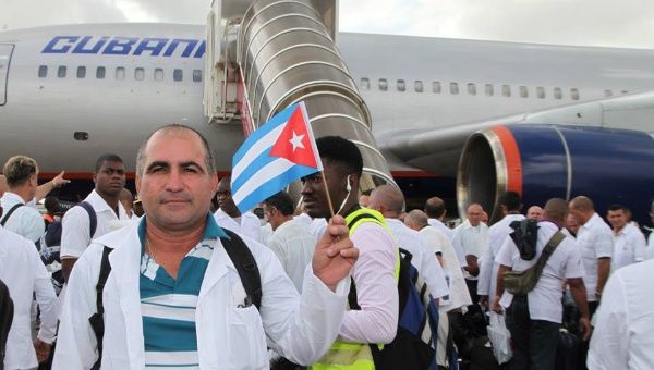 Cuban doctors and nurses arriving at the airport of Liberia to help treat victims of Ebola in the west Africa.