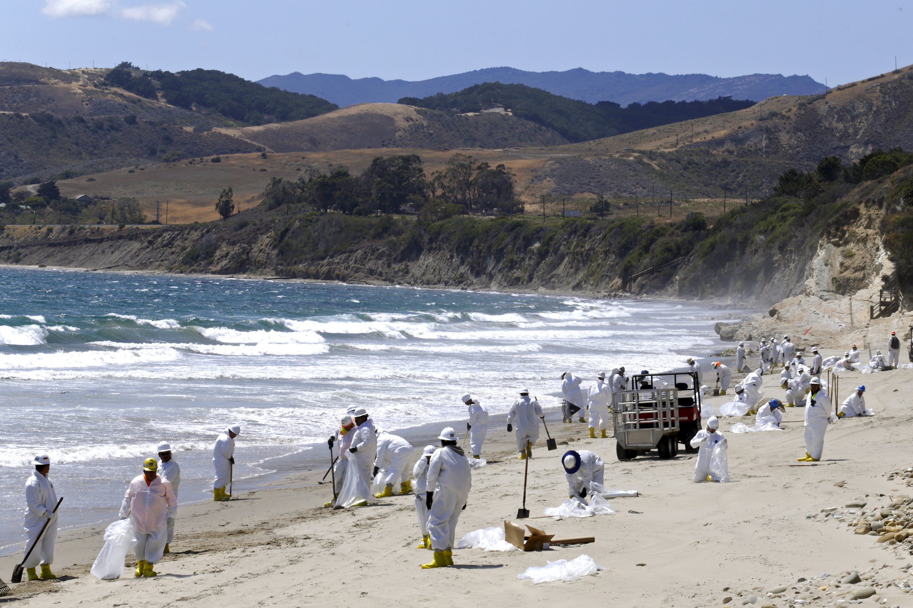 Crews clean up El Capitan State Beach after a massive oil spill on the Californian coast in Goleta, California May 22, 2015.