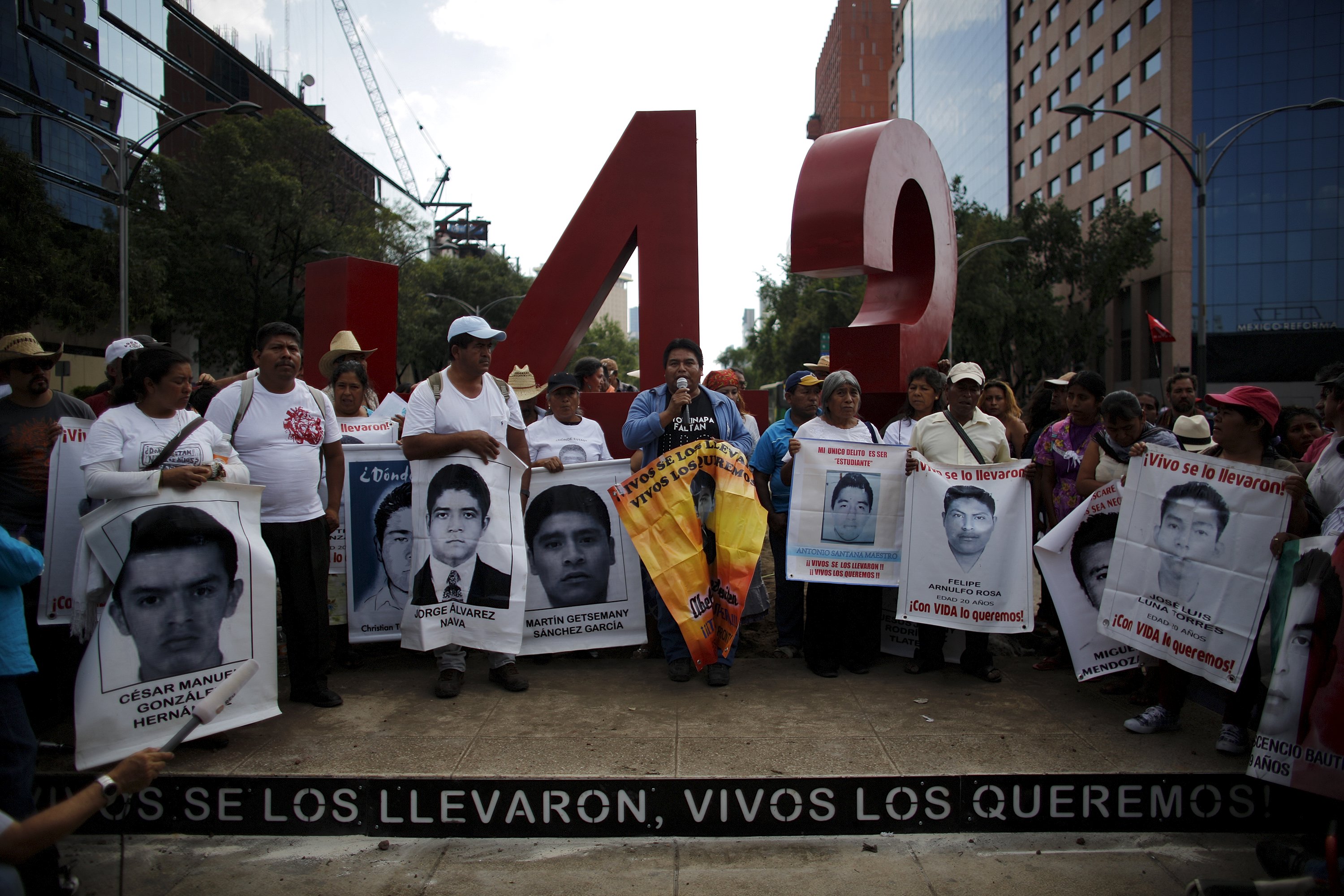 Relatives of missing students stand in front of a monument of the number 43 marking seven months since their disappearance, Mexico City, April 26, 2015.