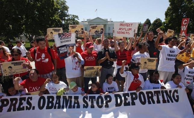 Anti-deportation protesters chant in front of the White House in Washington August 28, 2014.