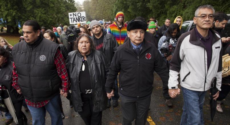Tsleil-Waututh Nation's Reuben George, Amy George, and Grand Chief Stewart Phillip participate in a protest against Kinder Morgan on Burnaby Mountain.