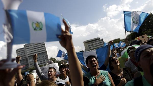 People sing the national anthem during a demonstration to celebrate the resignation of Guatemalan Vice President Roxana Baldetti.