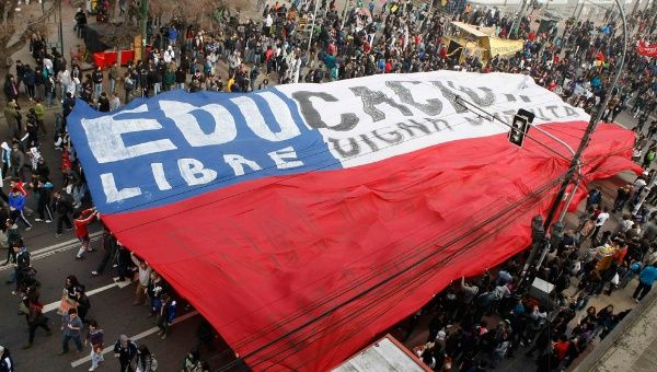 People carry the Chilean flag during a rally to demand changes in the public state education system in Valparaiso, Chile on August 9, 2011.