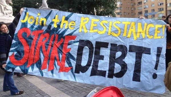 Protest banner advocates debt strike.