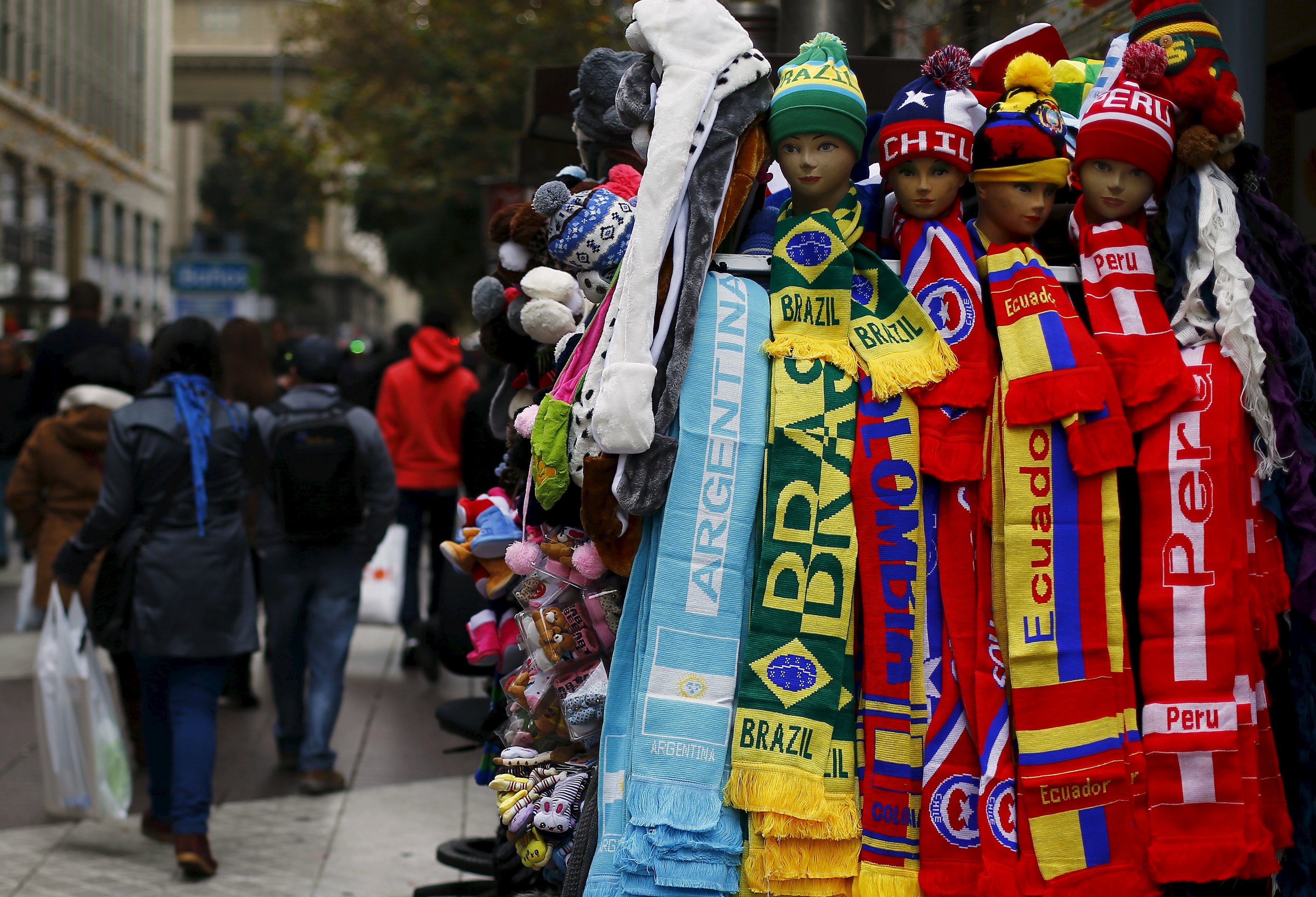 Caps and scarfs displaying the flags of countries which will play in the Copa America are pictured in a street market in Santiago, Chile, June 9, 2015.