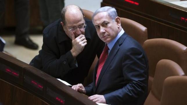 Israel's Defence Minister Moshe Yaalon (L) speaks with Prime Minister Benjamin Netanyahu during a session of the Knesset, the Israeli parliament, in Jerusalem December 1, 2014.