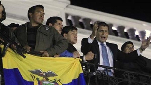 Ecuador's President Rafael Correa speaks from the balcony of the Carondolet Palace as hundreds of supporters gathered to greet him in Quito September 30, 2010.