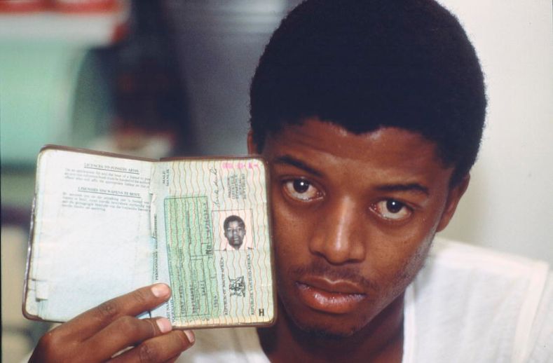 A Black South African showing his passbook issued by the government. Under apartheid, Blacks South Africans were required to carry passes that determined where they could live. 