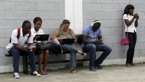 Young people use the internet via the free wifi at the studio of Cuban artist Alexis Leyva ''Kcho'' in Havana March 24, 2015.