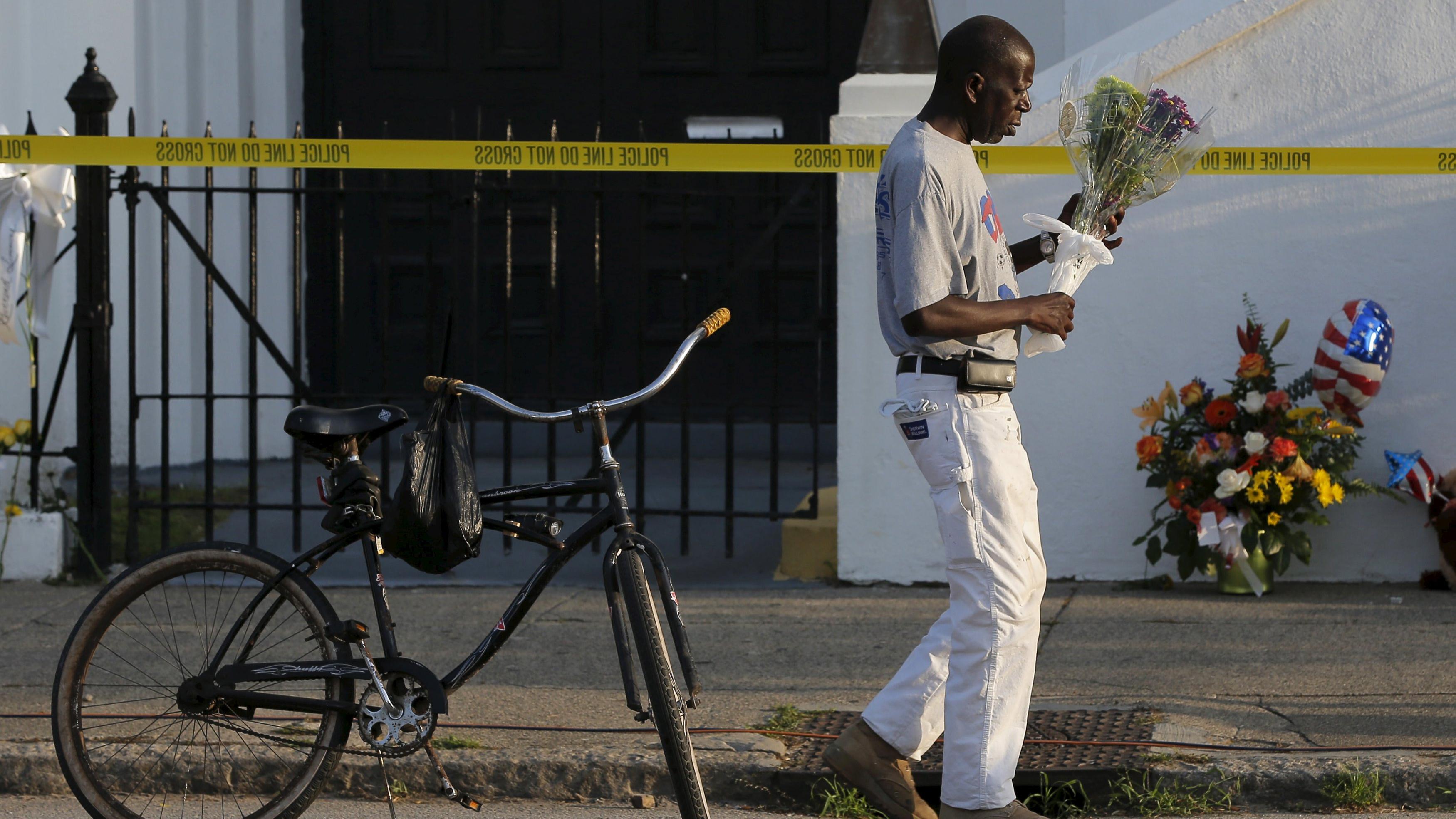 Larry Gorham pays his respects outside the Emanuel AME Church in Charleston, South Carolina June 19, 2015, two days after a mass shooting left nine dead.