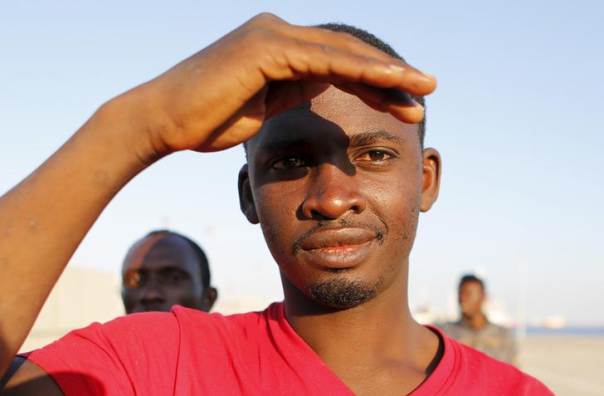 A migrant reacts after disembarking from the Spanish Civil Guard's ship in the Sicilian harbour of Augusta, Italy, June 23, 2015.