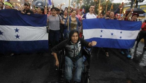 A man in a wheelchair yells slogans as he takes part in a march to demand the resignation of Honduras' President Juan Orlando Hernandez in Tegucigalpa on June 12, 2015. 