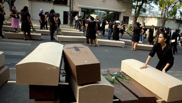 Honduran women's rights groups use coffins in a protest in capital Tegucigalpa to highlight ongoing violence against women.