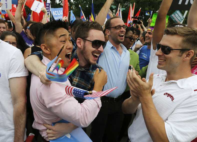 Gay rights supporters celebrate after the U.S. Supreme Court ruled that the U.S. Constitution provides same-sex couples the right to marry, outside the Supreme Court building in Washington, June 26, 2015. The court ruled 5-4 that the Constitution's guarantees of due process and equal protection under the law mean that states cannot ban same-sex marriages. With the ruling, gay marriage will become legal in all 50 states.