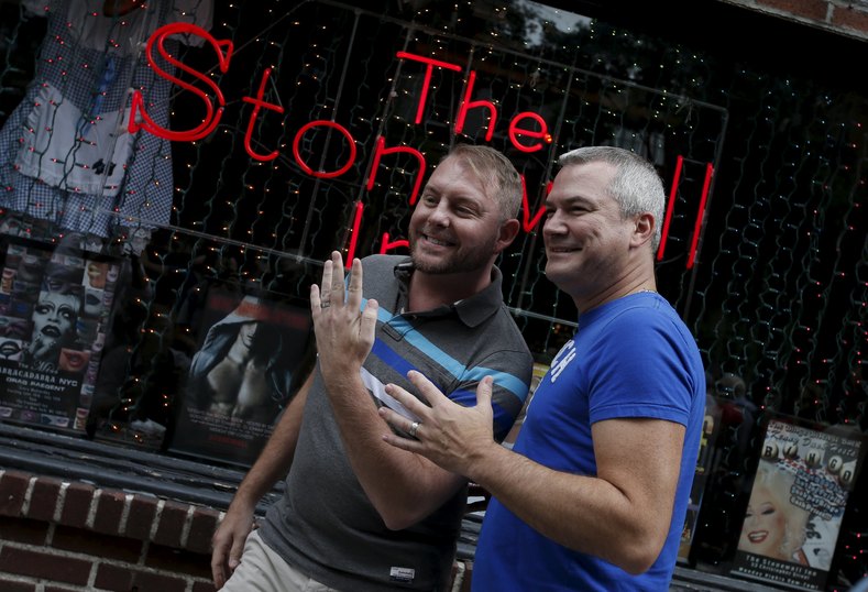 Charles Wooton (R) and Keith Newport, both from Atlanta, Georgia, show their wedding rings outside the Stonewall Inn in the Greenwich Village neighborhood of New York, June 26, 2015, following the announcement that the U.S. Supreme Court had ruled that the U.S. Constitution provides same-sex couples the right to marry in a historic triumph for the American gay rights movement.