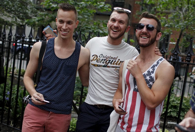 Men react together as they stand outside the Stonewall Inn in the Greenwich Village neighborhood of New York, June 26, 2015, immediately following the announcement that the U.S. Supreme Court had ruled that the U.S. Constitution provides same-sex couples the right to marry in a historic triumph for the Americangay rights movement.