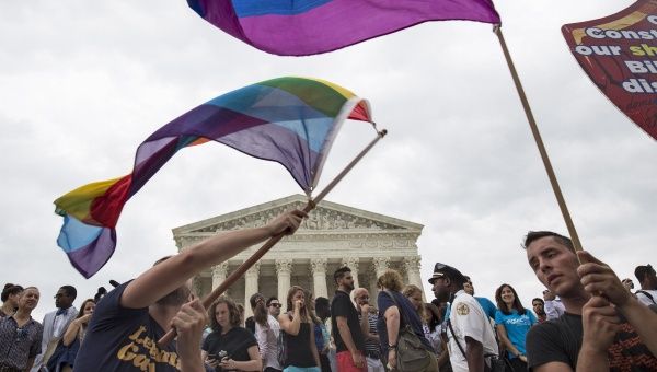 Supporters of gay marriage in Washington, D.C., wave the rainbow flag after the U.S. Supreme Court ruled on Friday that the U.S. Constitution provides same-sex couples the right to marry, June 26, 2015.