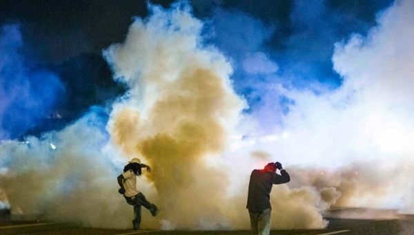 New report criticizes the police clampdown of the protests that ignited over the killing of Michael Brown, a black teenager, at the hands of a white Ferguson police officer on August 9, 2014.