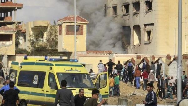 Egyptian residents and emergency personnel gather at the site of a car bomb explosion that targeted a police station in North Sinai's provincial capital of El-Arish on April 12, 2015. 