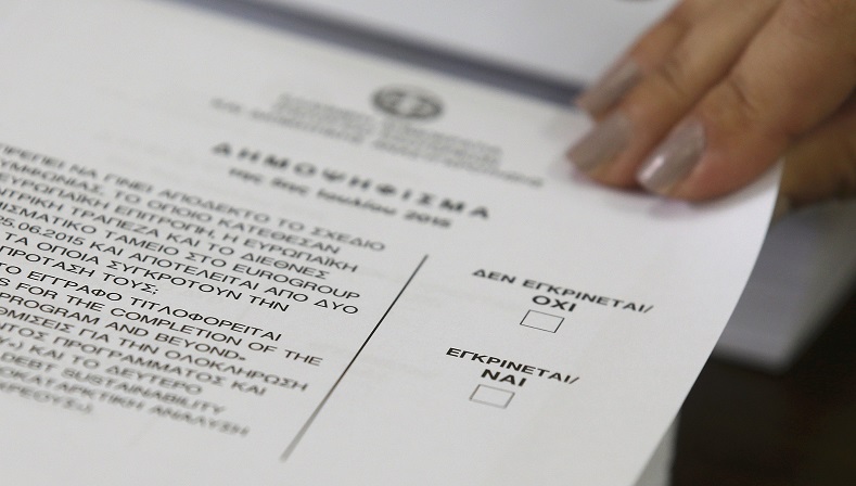 An official picks-up a a ballot at a polling station during a referendum vote in Athens, Greece, July 5, 2015.