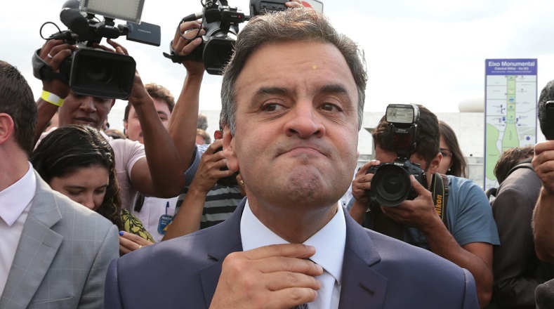 Brazil's main opposition party, the PSDB, re-elected leader Aecio Neves (C).