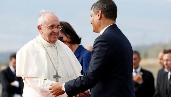 Pope Francis (L) shakes hands with President Correa after his speech at Quito airport.