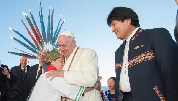 Pope Francis, standing alongside President Evo Morales (R), is welcomed in La Paz, Bolivia, July 8, 2015.