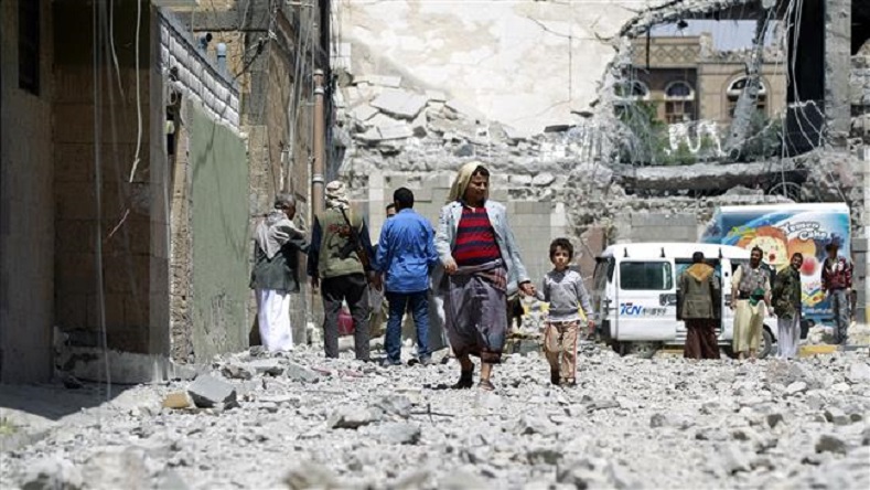 Yemenis gather amid rubble following an airstrike by Saudi Arabia in the capital, Sana’a, June 8, 2015.