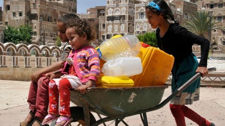 Children fetching water in Yemen's capital Sana'a. Fuel shortages, causing further food and water shortages, put thousands of children at risk.